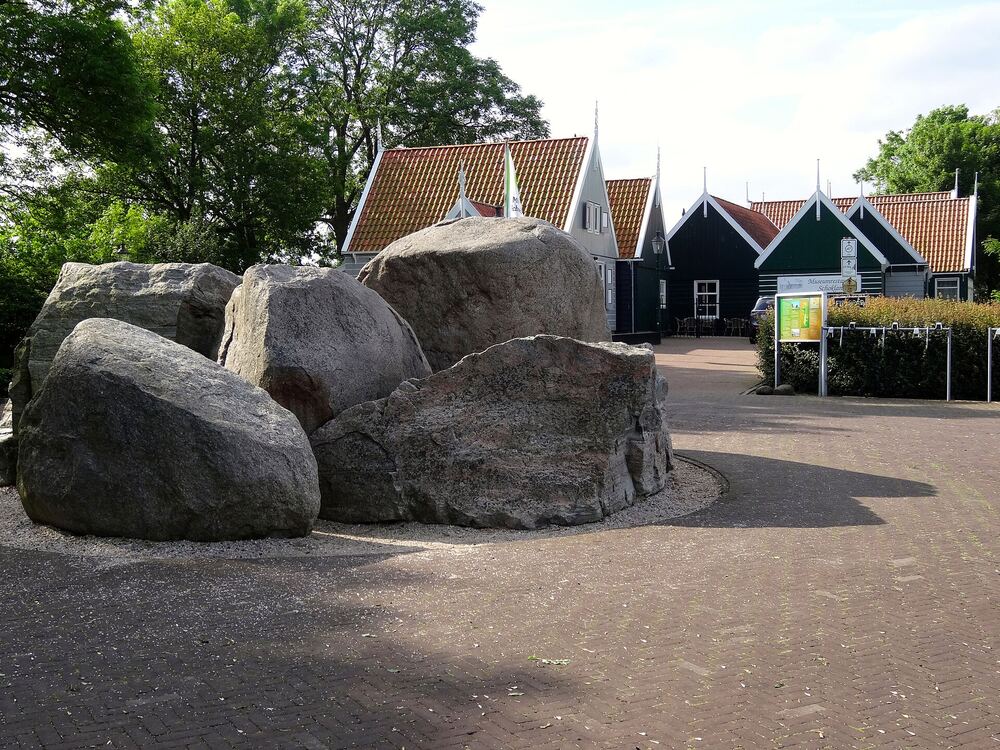Zwerfkeien en historische houten huisjes bij Museum Schokland op de Middelbuurt, op een zonnige dag